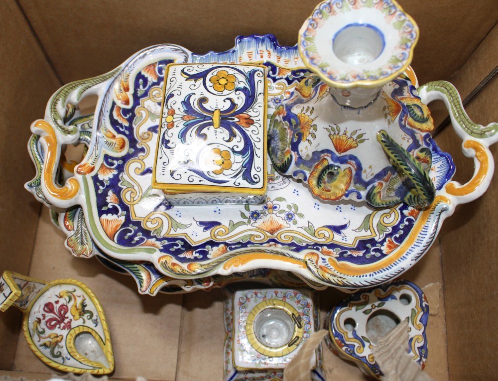 A collection of five St Malo faience dishes, a similar chamberstick, two inkwells, an unsigned oil lamp and a Deruta casket